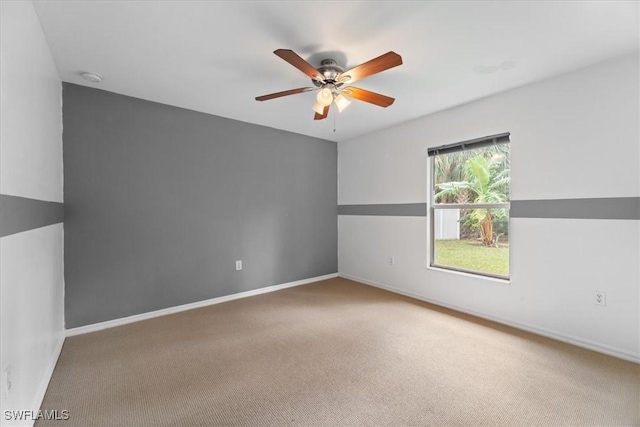 empty room featuring ceiling fan and carpet floors