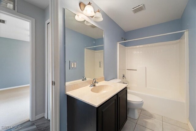 full bathroom featuring tile patterned flooring, vanity, toilet, and shower / bathtub combination