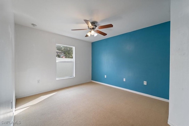 empty room with carpet flooring and ceiling fan