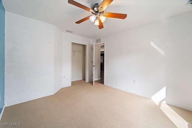 empty room with ceiling fan and light colored carpet