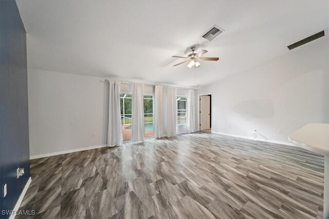 spare room featuring wood-type flooring and ceiling fan