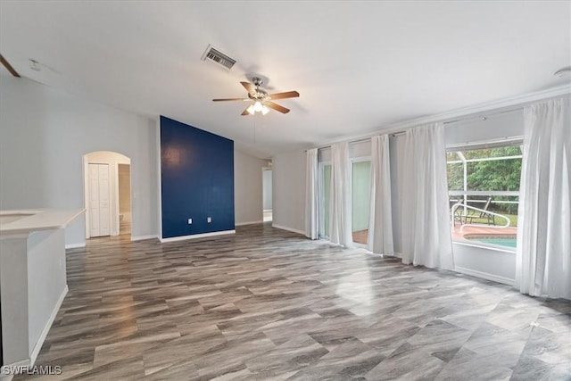 unfurnished living room with ceiling fan