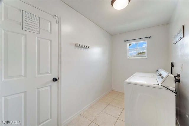 laundry room featuring light tile patterned floors and washing machine and dryer