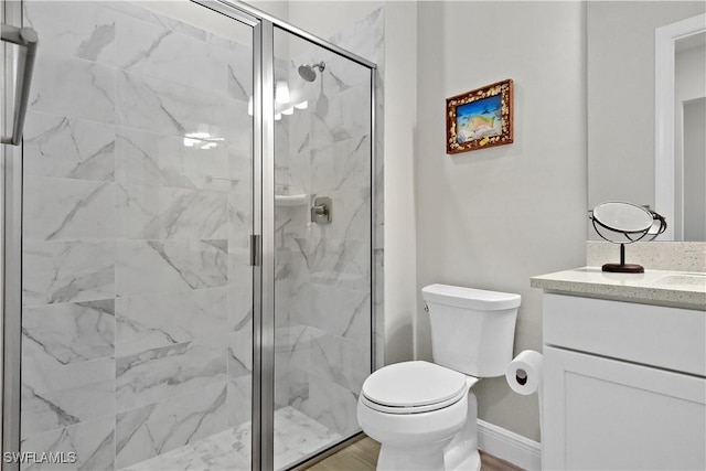 bathroom with wood-type flooring, vanity, toilet, and an enclosed shower