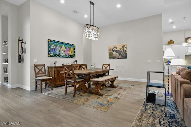 dining room featuring light hardwood / wood-style floors and an inviting chandelier