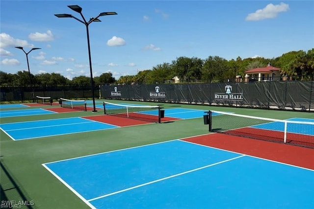 view of tennis court with basketball hoop