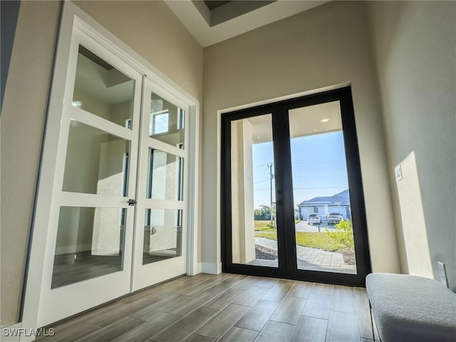 entryway featuring a towering ceiling and french doors