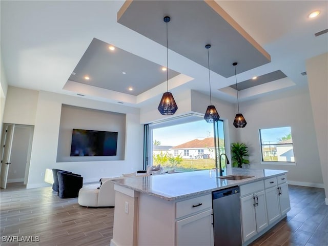 kitchen featuring white cabinetry, a tray ceiling, dishwasher, and pendant lighting