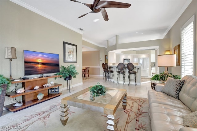 tiled living room featuring ceiling fan and ornamental molding