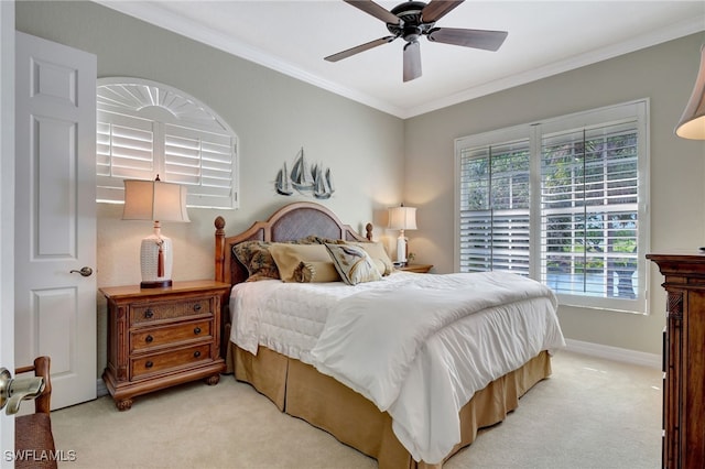 carpeted bedroom featuring ceiling fan and crown molding