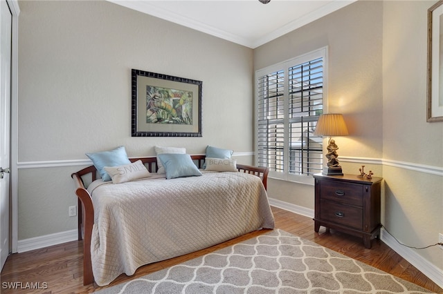 bedroom with hardwood / wood-style flooring and ornamental molding