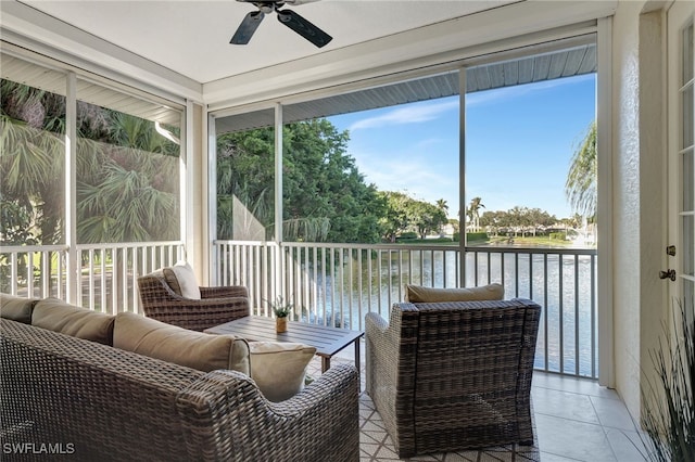 sunroom / solarium featuring a water view and ceiling fan