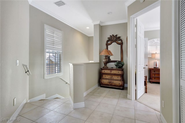 corridor with ornamental molding and light tile patterned flooring