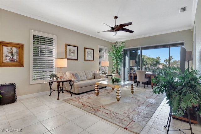 living room with ceiling fan, ornamental molding, and light tile patterned flooring