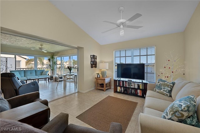 living room featuring ceiling fan, light tile patterned floors, and lofted ceiling