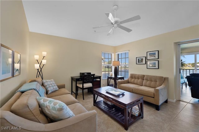 tiled living room featuring plenty of natural light and ceiling fan