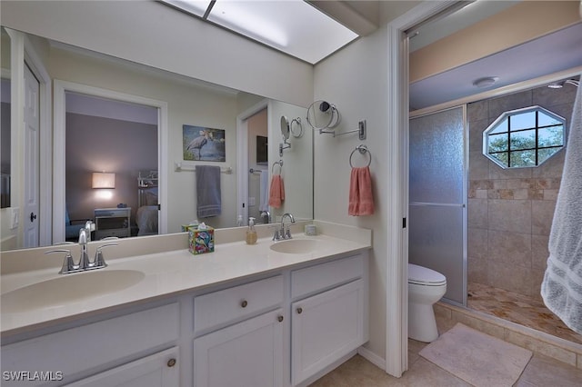 bathroom featuring tile patterned flooring, vanity, and walk in shower