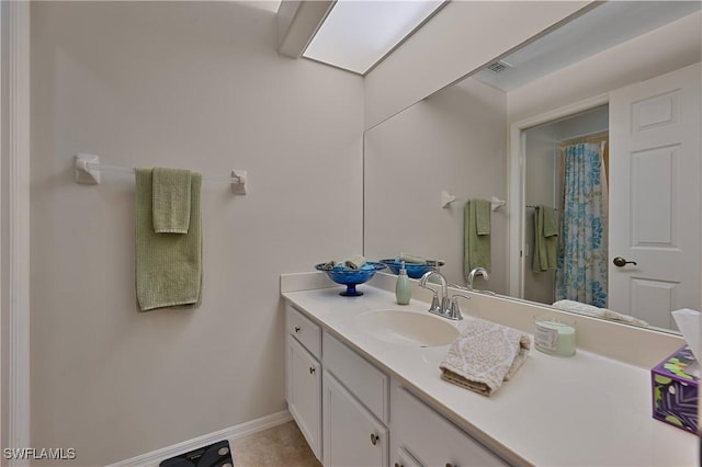 bathroom featuring tile patterned flooring and vanity