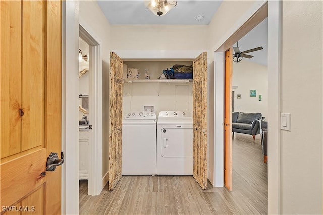 laundry area featuring washer and clothes dryer, ceiling fan, and light wood-type flooring