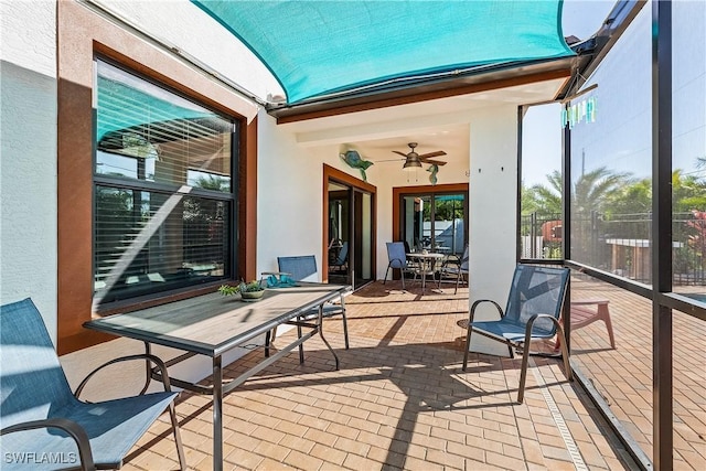 sunroom / solarium featuring ceiling fan