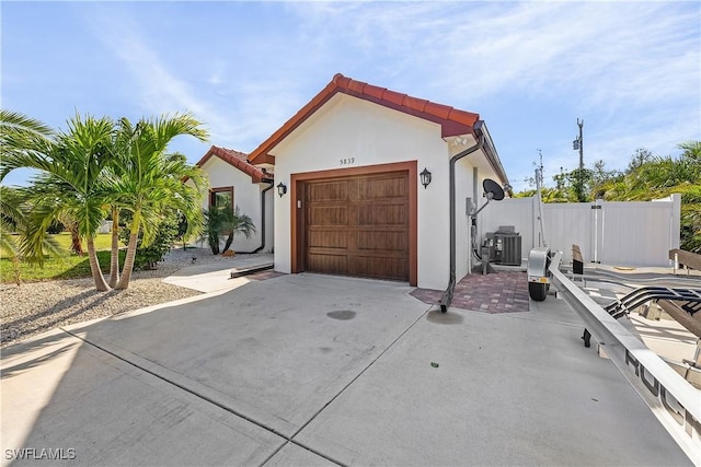 view of front of house featuring cooling unit and a garage