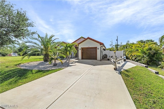 view of front of property featuring a garage and a front lawn