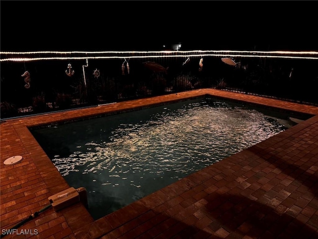 view of pool at night