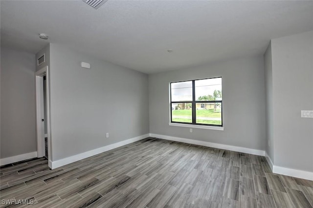 spare room featuring light wood-type flooring