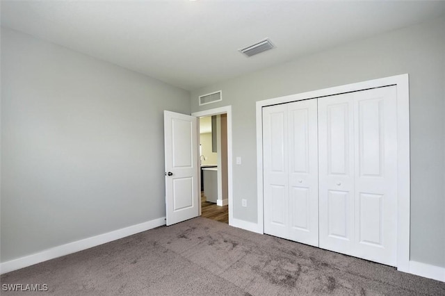 unfurnished bedroom with a closet and carpet floors