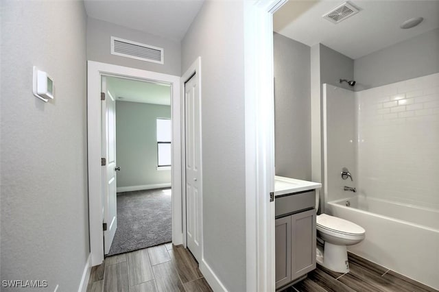 full bathroom featuring vanity, toilet, and tiled shower / bath combo