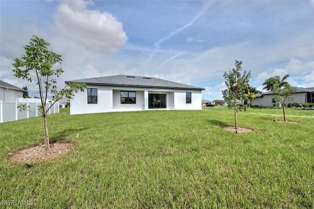 rear view of house with a lawn