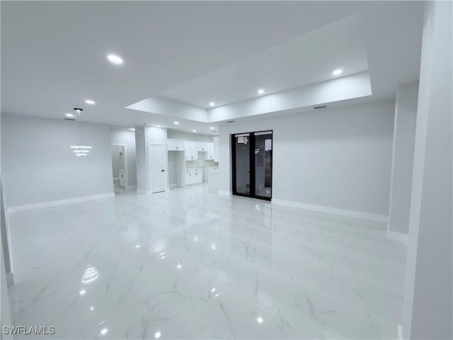 spare room featuring a tray ceiling