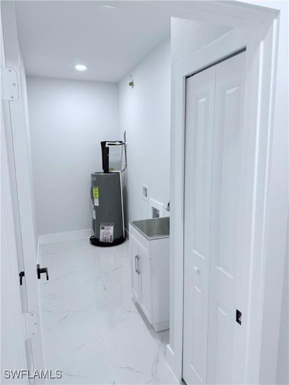 laundry area featuring cabinets, electric water heater, and hookup for a washing machine