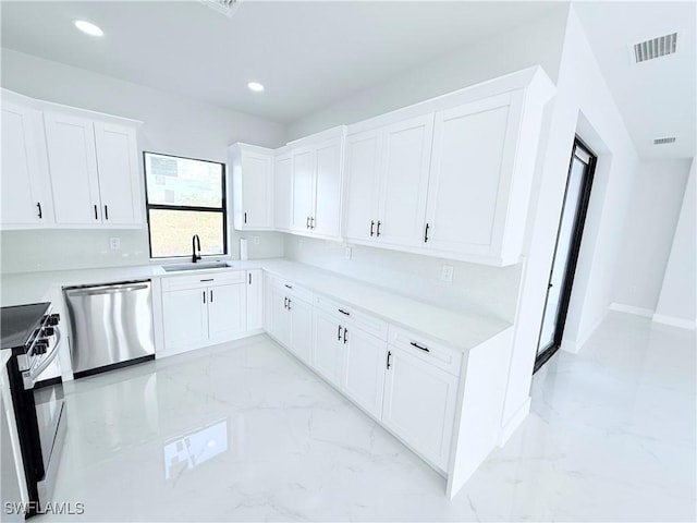 kitchen featuring dishwasher, white cabinetry, sink, and range