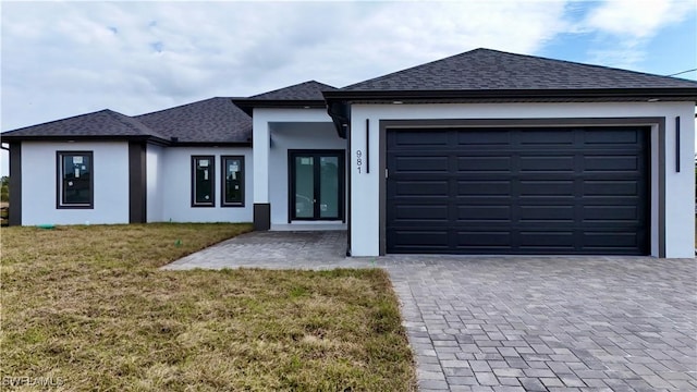 view of front facade featuring a front lawn and a garage