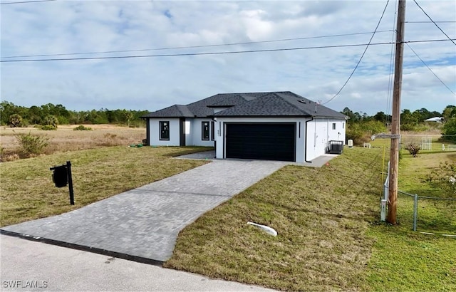 view of front of property with a garage and a front lawn