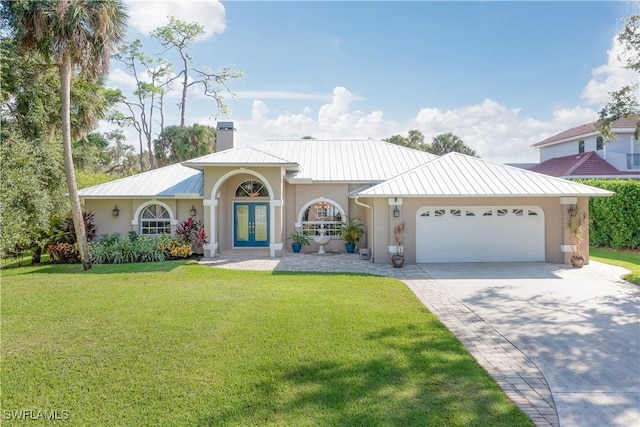 view of front of house featuring french doors, a front lawn, and a garage