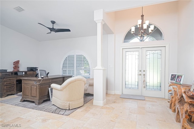 entryway with ornate columns, french doors, and ceiling fan with notable chandelier