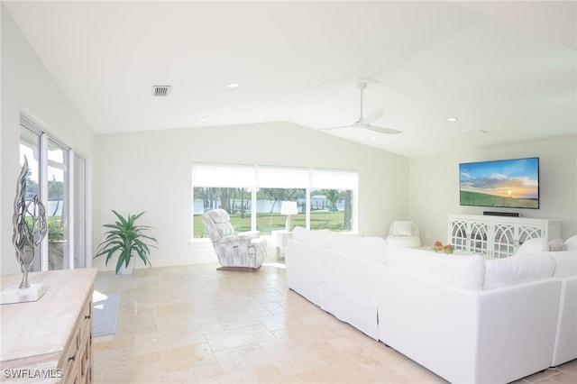 living room featuring plenty of natural light, ceiling fan, and vaulted ceiling