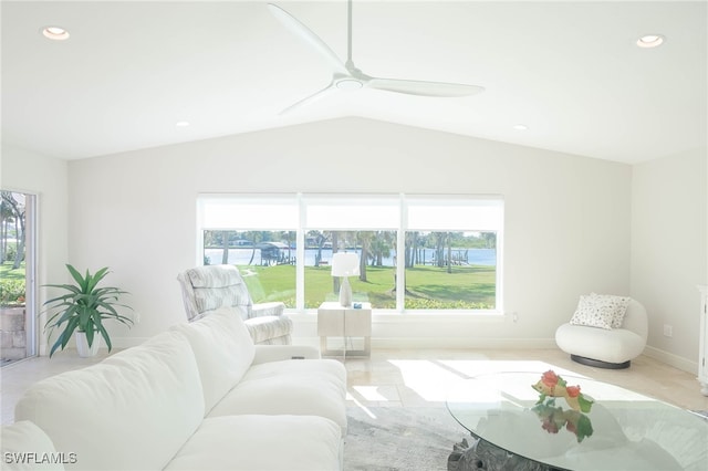 carpeted living room featuring lofted ceiling, ceiling fan, and a healthy amount of sunlight