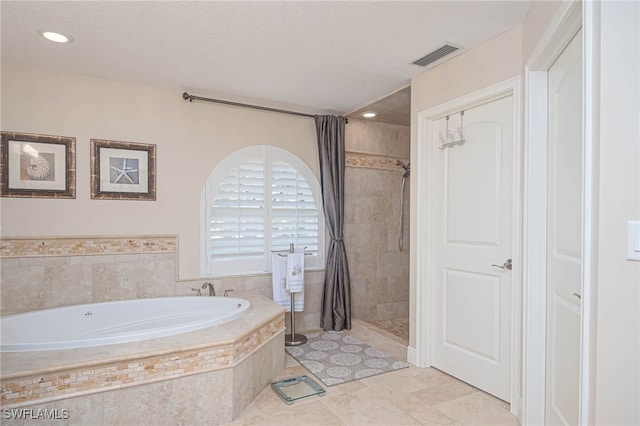 bathroom with shower with separate bathtub