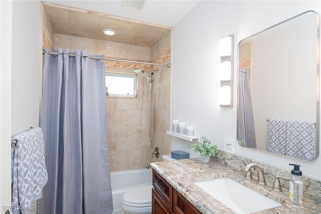 full bathroom with vanity, toilet, and shower / tub combo