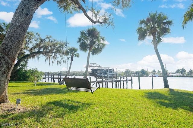 view of yard featuring a water view and a dock