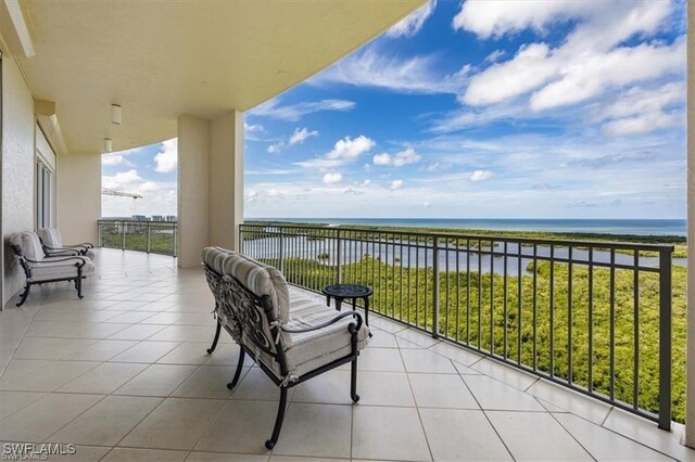 balcony with a beach view and a water view