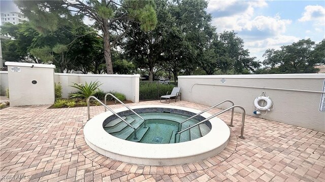 view of pool featuring a community hot tub and a patio