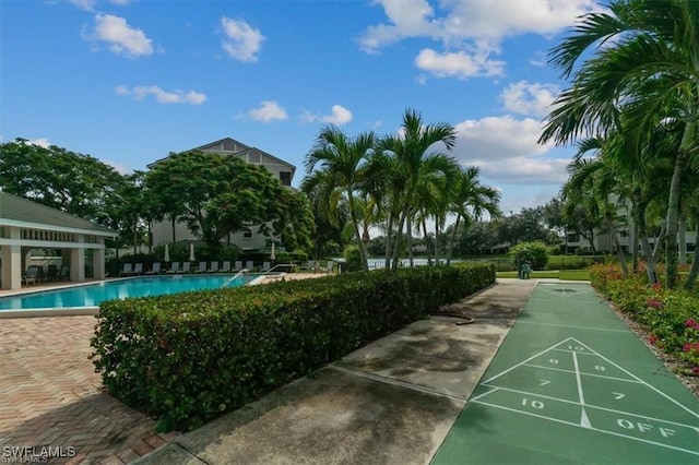 view of property's community with a pool and shuffleboard