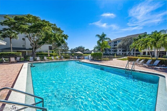 pool featuring a patio area and fence