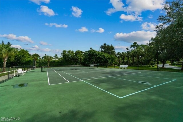 view of tennis court with fence