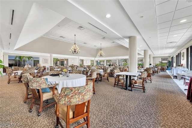 dining room with carpet flooring, a notable chandelier, and a towering ceiling