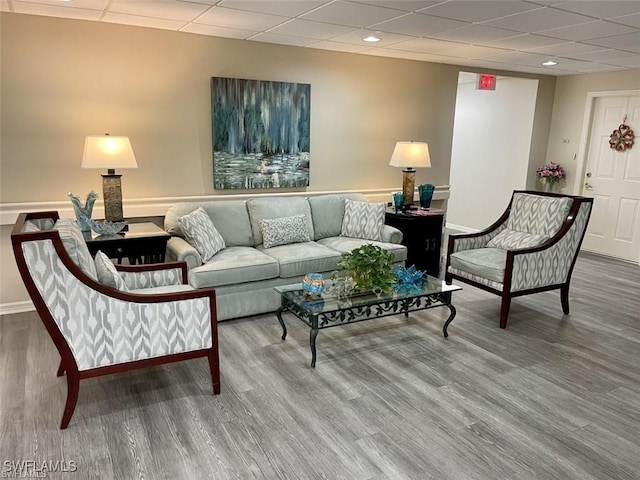 living room featuring a paneled ceiling and wood finished floors